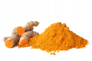 Turmeric rhizome and powder on white background